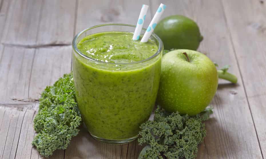 Glass of green juice with apples and kale