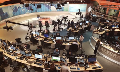 Al-Jazeera staff work at the TV station in Doha, Qatar. 