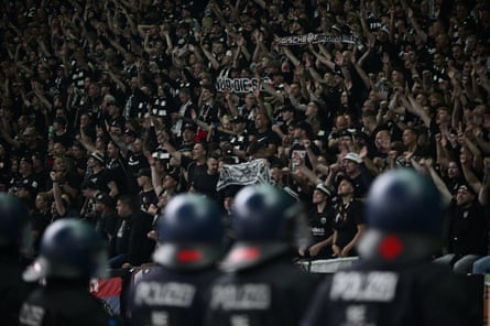 Riot police keep an eye on Frankfurt fans after a match against RB Leipzig.