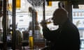 Man drinking beer alone in pub