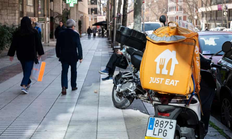 A motorbike courier from the online food order and delivery service company, Just Eat, in Spain.