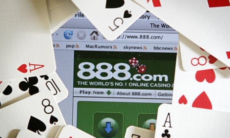 The online gambling website of 888 holdings is pictured surrounded by a deck of cards.