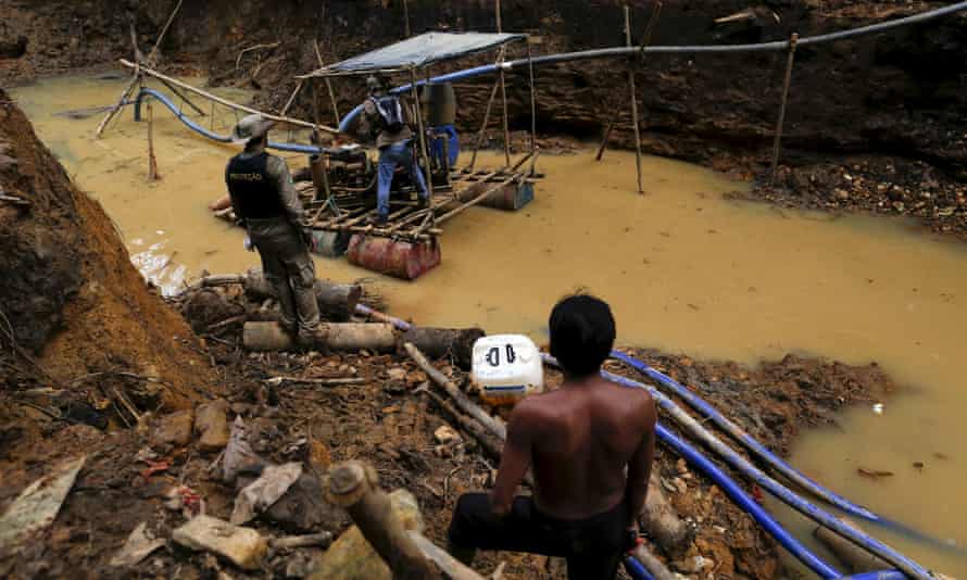 A member of the Yanomami community watches as Brazil’s environmental agency closes down an illegal goldmine