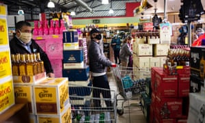 Customers queue to buy alcohol at a supermarket amid the ongoing coronavirus emergency lockdown in Johannesburg, South Africa, 18 August 2020.