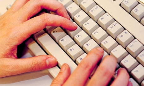 A person's hands on a computer keyboard