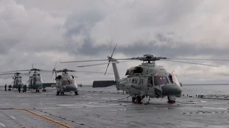 Four helicopters on the deck of an assault ship