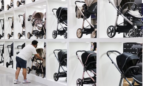 A man looks at a variety of prams in seoul