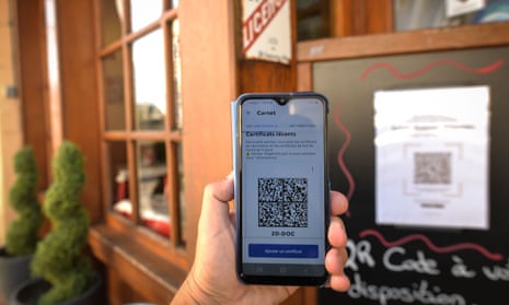 A person checks into a restaurant in France using a QR code with an EU Covid digital vaccine certificate.
