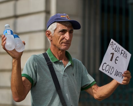 A street vendor sells bottles of water during a heatwave in Madrid, Spain.