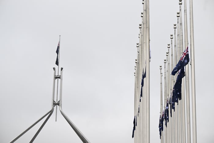 The Australian flag flies at half mast on top of Parliament House in Canberra.