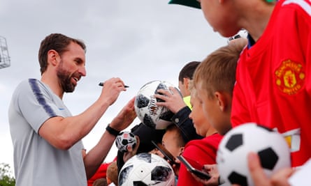 Gareth Southgate signs autographs for young fans during England training at the Spartak Zelenogorsk ground in Zelenogorsk, near St Petersburg.