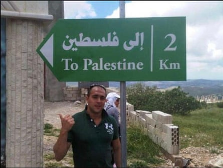 Munib al-Masri Jr, standing by a street sign showing way to Palestine hours before he was shot