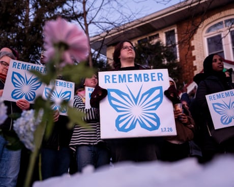 people holding signs saying 'Remember'
