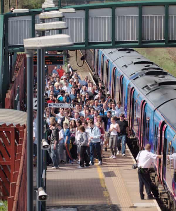 Fans at Horwich Parkway railway station head to a Bolton game.