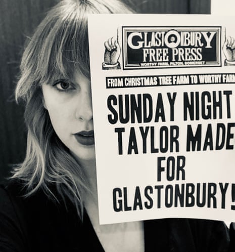 Taylor Swift holding up a customised version of the Glastonbury Free Press.