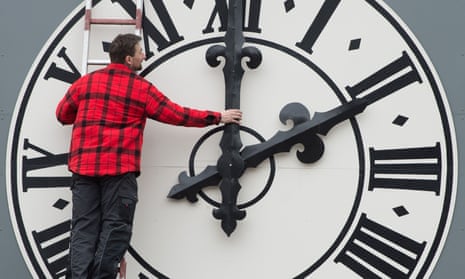 A technician changes a clock on a church in Dresden
