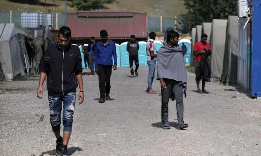 Migrants walk through the Lipa camp, outside Bihać, Bosnia