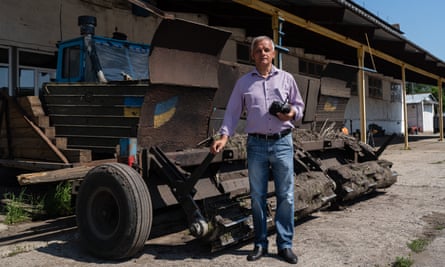 Kharkiv farmer Oleksandr Kryvtsov with the mine-clearing robot he built from bits including a tractor and an abandoned Russian tank