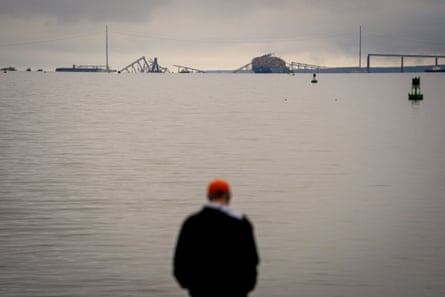 Person blurred out in front of water and horizon of wrecked bridge