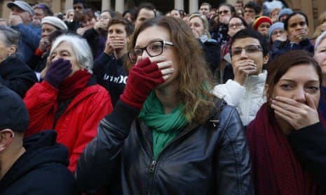 Supporters cover their mouths during a protest by doctors and allied health professionals in Sydney to oppose the secrecy provisions of the Border Force Act, in July 2015. 