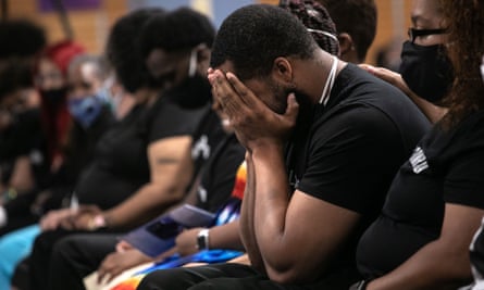 Family members mourn the death of Conrad Coleman Jr from Covid-19 following his funeral service on 3 July in New Rochelle, New York. The African American community has been especially hard-hit by the coronavirus pandemic.