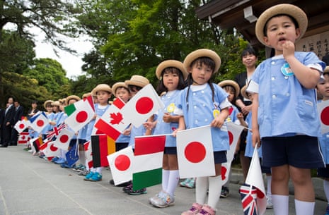 A welcome group of schoolchildren wait for the G7 leaders to arrive for their tour of the Ise Jingu shrine.