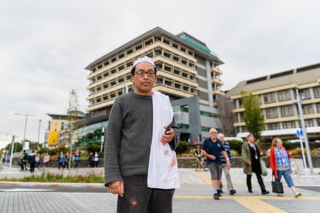 Hamzah Noor Yahaya, a survivor of the shootings at Al Noor mosque, stands in front of Christchurch Hospital and waits to be picked up by his wife.