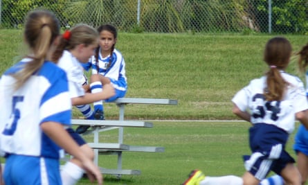 jazz jennings sits on the bench in soccer uniform