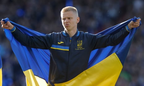 Ukraine's Oleksandr Zinchenko holds a Ukrainian flag ahead of a match in June 2022.