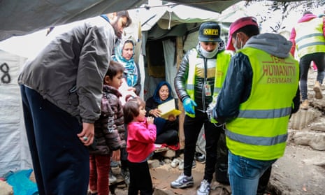 Face masks are distributed to migrants and refugees on the island of Lesbos.