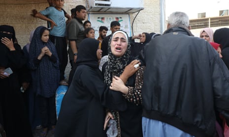Relatives of Palestinians who were killed in Israeli attacks mourn as they receive the dead bodies from the morgue of al-Aqsa hospital in the Gaza Strip.