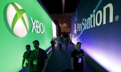 A Microsoft Xbox sign opposite a Sony PlayStation sign at E3 in LA in 2015.