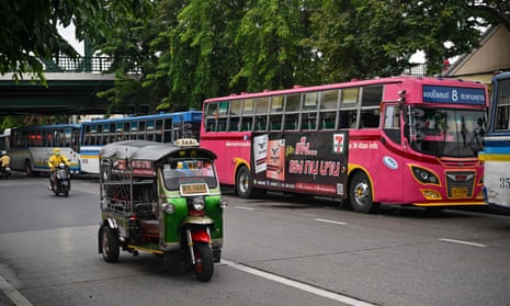 In Bangkok the ‘pink devil’ bus competes for space with tuk-tuks, cars and motorbikes