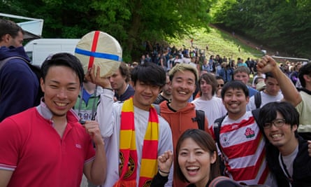 Ryoya Minani poses with his friends after winning an uphill race