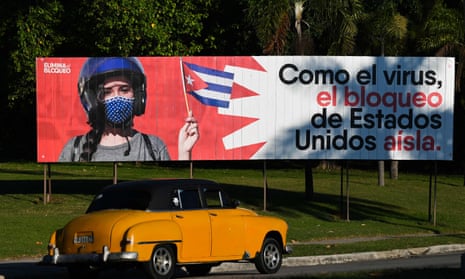 CUBA-US-EMBARGO<br>An old American car drives near a banner reading As the virus, the United States blockade isolates, in Havana, on January 31, 2021. - Cuba's deputy minister for foreign relations Carlos Fernandez de Cossio hit out at the hypocrisy and "cruelty" of the United States embargo against the island nation in an interview with AFP, adding that Washington has a nerve trying to teach morality to others. (Photo by YAMIL LAGE / AFP) (Photo by YAMIL LAGE/AFP via Getty Images)