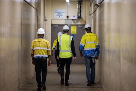 Sydney Water staff make their way to the sedimentation tanks at the Malabar wastewater treatment plant