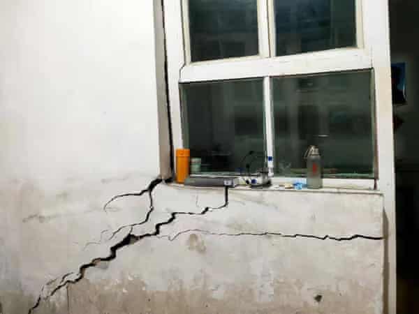 Cracks are seen at Yu Jinhua’s house in Shanxi.
