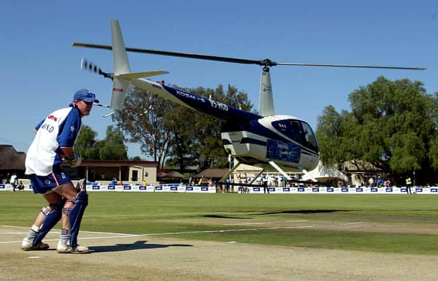 England batsman Andrew Strauss practices on the wicket while a helicopter uses its down draft to dry out the pitch.