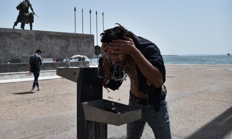 A man cools off with water during a heatwave in Thessaloniki