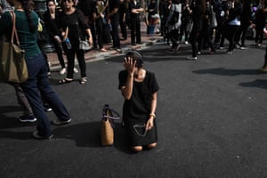 A mourner cries in the street, Bangkok
