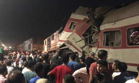 People surround two passenger trains which collided in Egypt's Nile delta city of Zagazig.