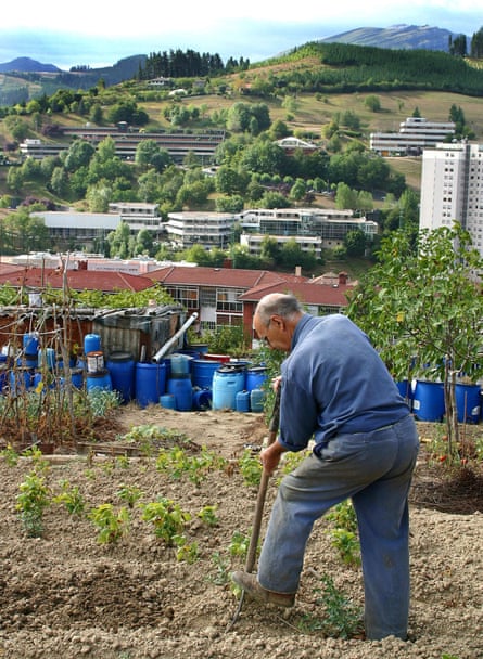 A man works on his land in the mountains overlooking the Mondragon Cooperative.