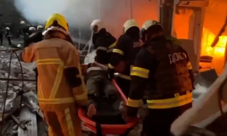 Rescue workers carry a person from the rubble following a rocket attack in a location given as Cherkasy, Ukraine in this screengrab taken from a handout video released 21 September 2023.