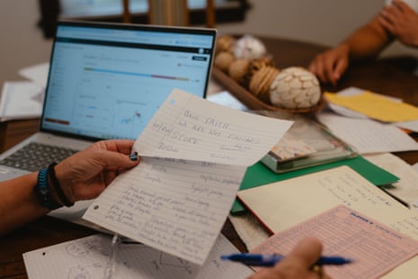 A woman holds a sheet of paper