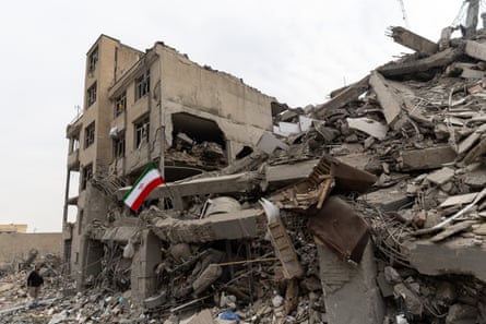 An Iranian flag flying outside a destroyed home in Tehran.