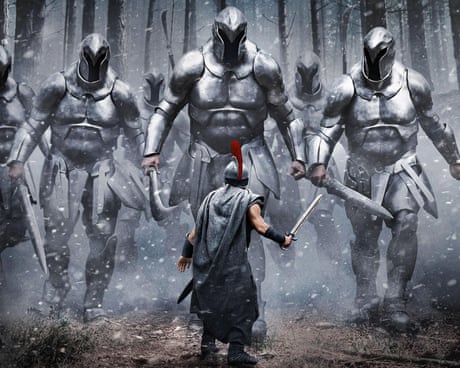 man holding a sword faces giant armored figures in a forest