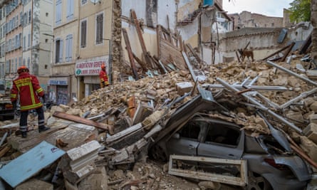 Firefighters remove rubble at the site where two buildings collapsed on Monday in Marseille, southern France