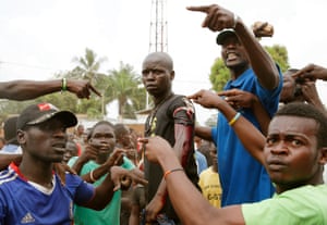 An angry crowd parades a man wounded as regional peacekeepers tried to evacuate Muslim clerics from a in Bangui, Central African Republic, in 2013.