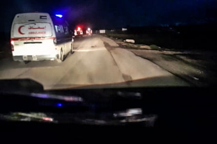A Red Crescent ambulance with its emergency lights flashing