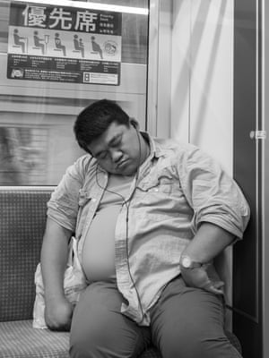 A man sleeping on an underground train Tokyo